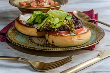 Portobello mushroom burger with pesto and goat cheese and side slow-cooker ham and cannellini bean soup