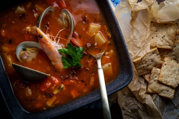 Fresh hot Manhattan Clam Chowder soup with whole head-on shrimp
