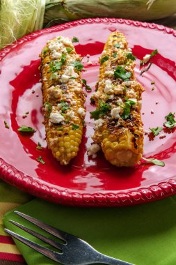 Meksika sokak mısırı elote olarak da bilinir acı biberli mayonez ve cotija peyniri ile servis edilir.