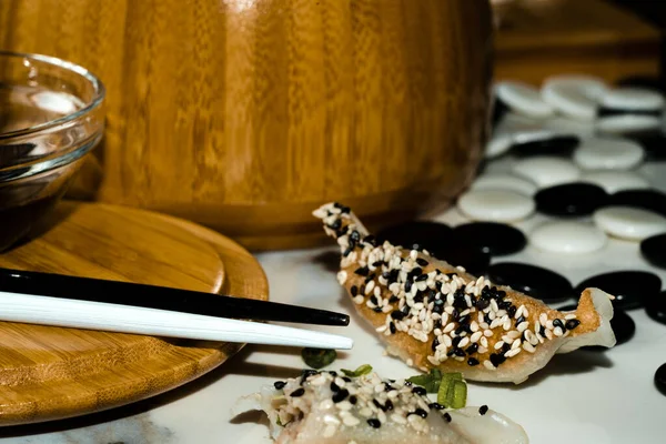 Playing Board Game While Eating Chinese Dumplings Tuxedo Sesame Seeds — Stock Photo, Image