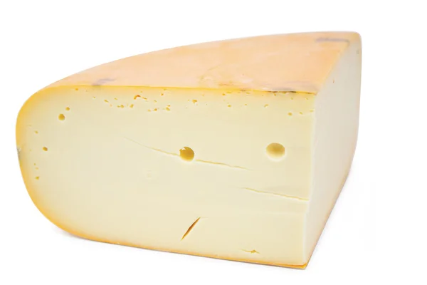 Gran pedazo de queso sobre fondo blanco —  Fotos de Stock