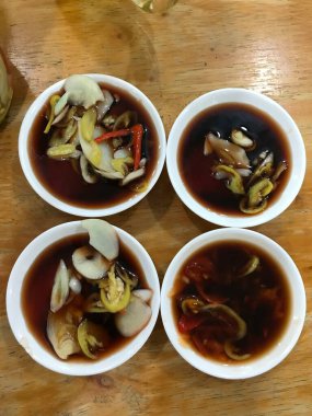 Assorted Asian stir-fried foods sizzling in a wok colorful vegetables meats and noodles savory aromatic sauce traditional flavorful cuisine vibrant street food or home-cooked meal presentation