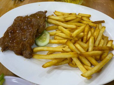 Assorted Asian stir-fried foods sizzling in a wok colorful vegetables meats and noodles savory aromatic sauce traditional flavorful cuisine vibrant street food or home-cooked meal presentation