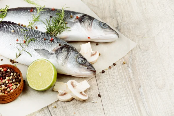 Raw seabass fish on the wooden board Royalty Free Stock Photos