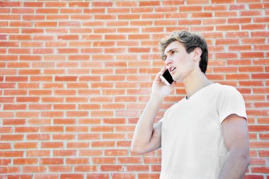 Genç adam telefonda konuşuyor