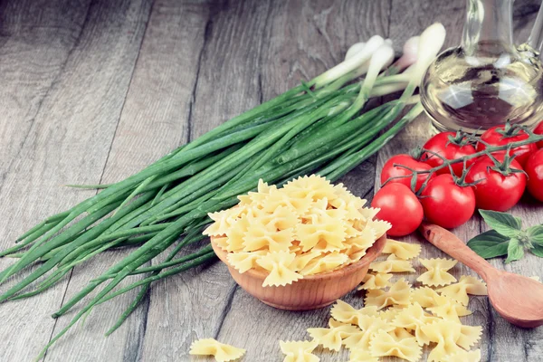 Raw farfalle pasta in bowl — Stock Photo, Image