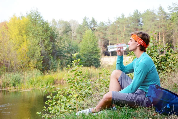 Young man is drinking water Stock Image