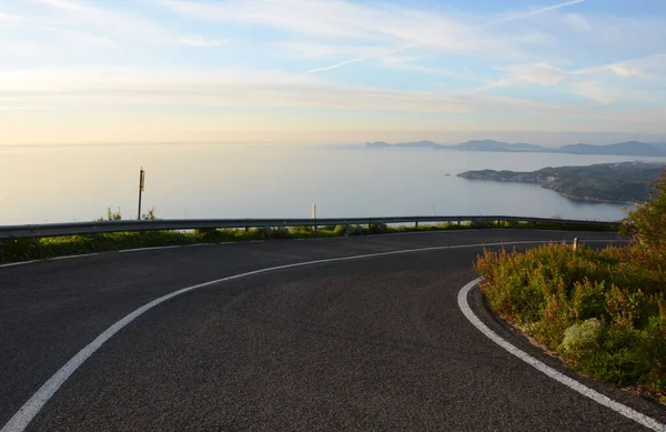 mediterranean coastal road in alghero, sardinia, italy