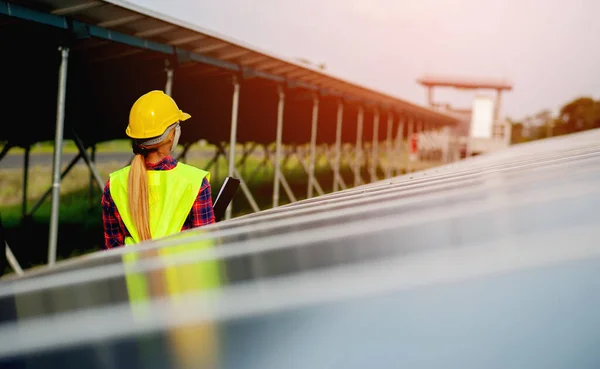 A young female solar cell engineer is working hard. Working in alternative energy Solar energy