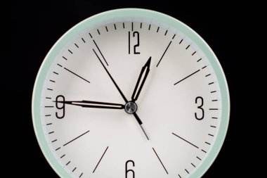 Clock tells the time of work and life. Concept of time and quality time management. High quality studio photography.