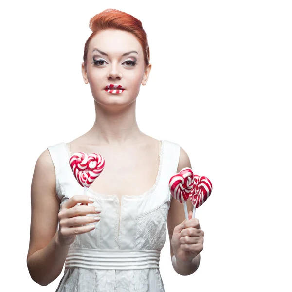 Happy red-haired girl holding candy — Stock Photo, Image