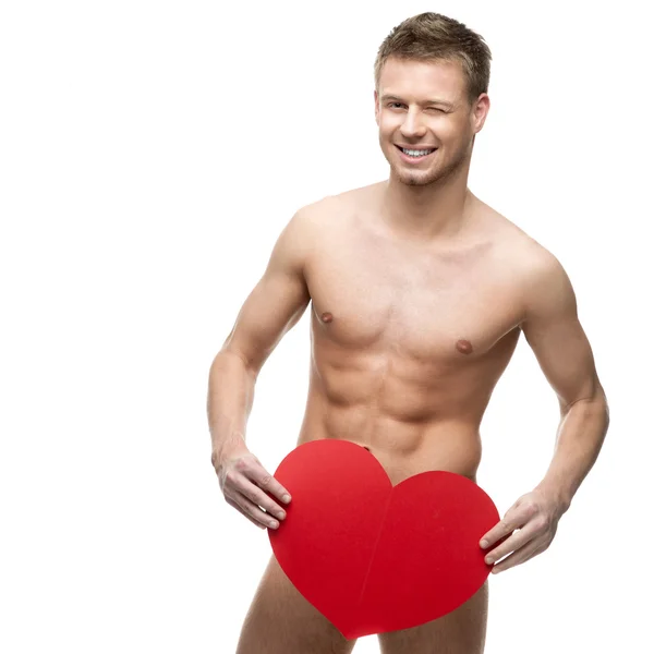 Funny naked man holding big red paper heart — Stock Photo, Image