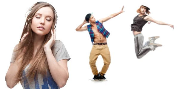 Young woman listening music and two dancers on background — Stock Photo, Image