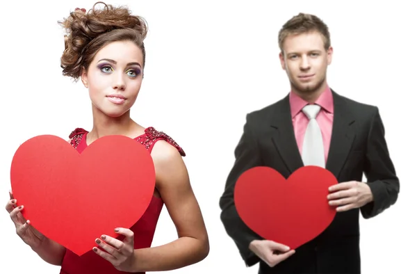 Young sensual woman and handsome man holding red heart on white — Stock Photo, Image