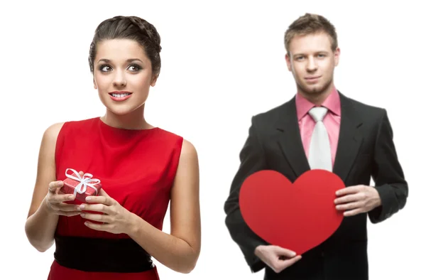 Young cheerful woman and handsome man holding red heart on white — Stock Photo, Image