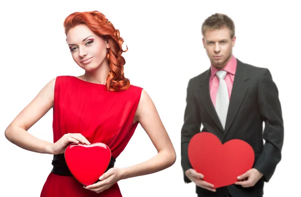 Young cheerful woman and handsome man holding red heart on white — Stock Photo, Image