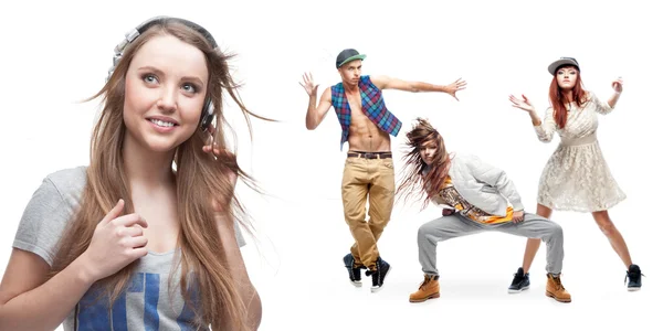 Young woman listening music and group of dancers on background — Stock Photo, Image