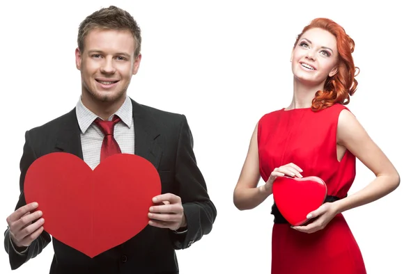 Young cheerful woman and handsome man holding red heart on white — Stock Photo, Image