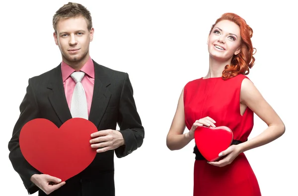 Young handsome man holding red heart and cheerful woman on white — Stock Photo, Image