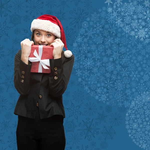 Business woman in santa hat holding gift — Stock Photo, Image