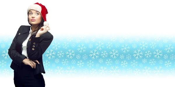 Young business woman in santa hat standing over winter backgroun — Stock Photo, Image