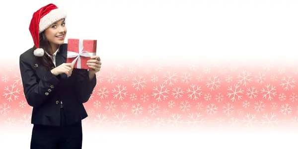 Business woman in santa hat holding gift Stock Photo