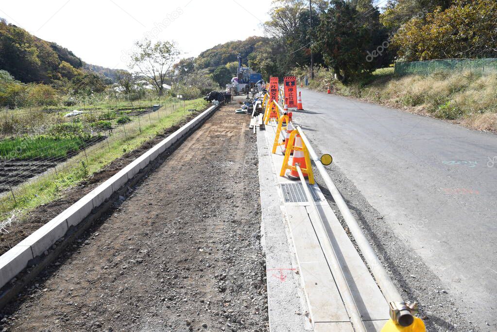 Installation construction of street gutter on the road.