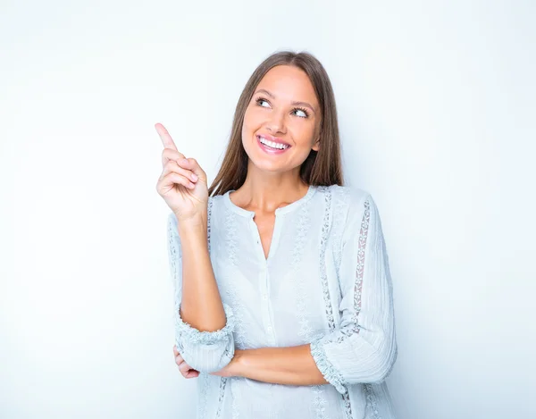 Happy woman pointing finger up — Stock Photo, Image