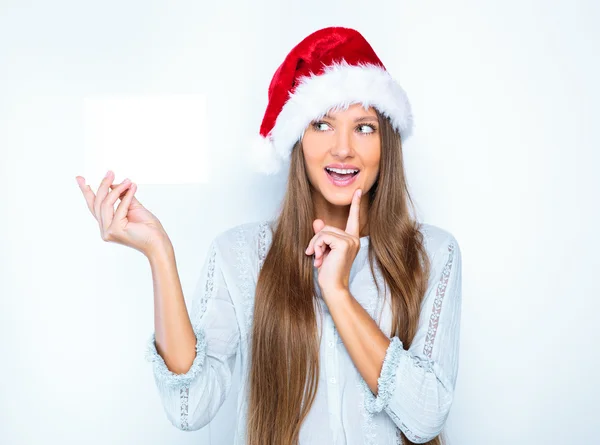 Girl in santa hat with blank card — Stock Photo, Image