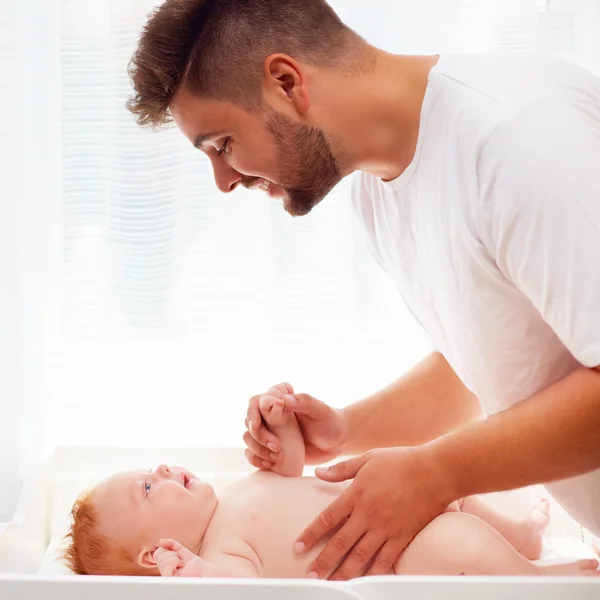 Happy father taking care of infant baby — Stock Photo, Image