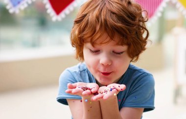 Sevimli mutlu çocuk, avuçlarından parıltı saçan çocuk.