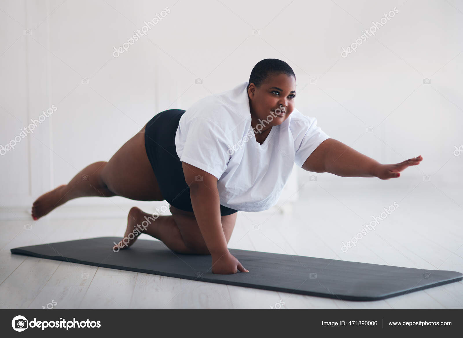 fat woman doing yoga in the park in the lotus position Stock Photo