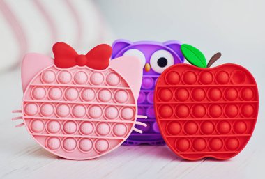 trending colorful sensory toys. pop it fidget toy set clipart