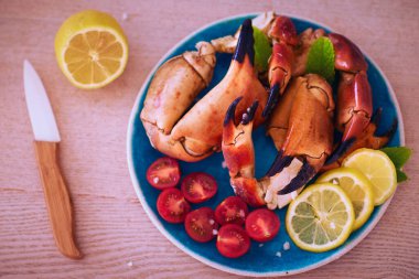 Pişmiş ve yengeç pençeli, kiraz domatesli ve limonlu, Akdeniz ürünleri mutfağı.