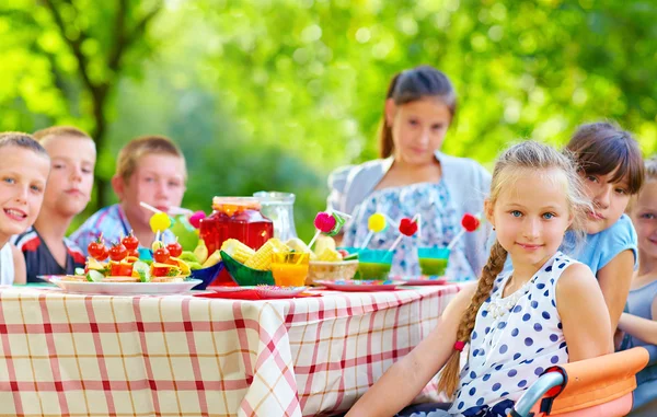 happy kids around picnic table