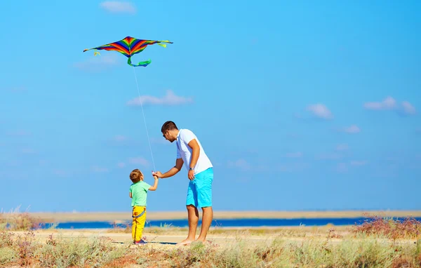 Father and son having fun, playing with kite together — Stock Photo, Image