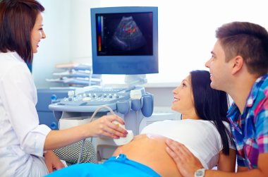 happy couple on ultrasound, determines the gender of child clipart