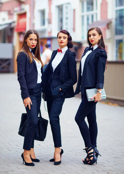 Beautiful girls in black suits posing on the street — Stock Photo, Image