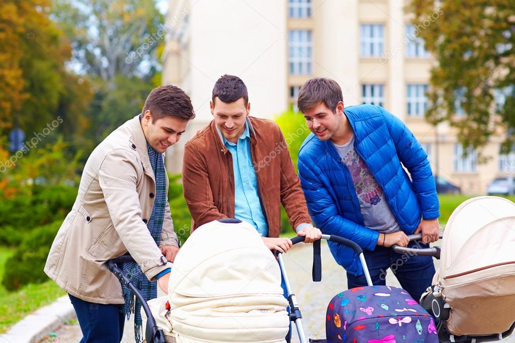 happy fathers on parental leave, walking in city park