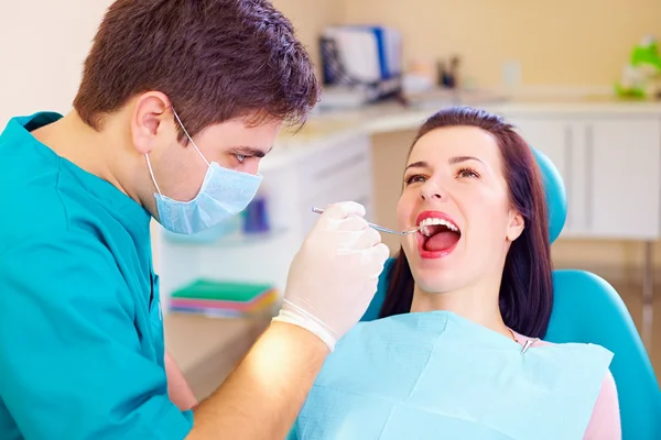 Femeie tânără care vizitează dentistul în clinică — Fotografie, imagine de stoc