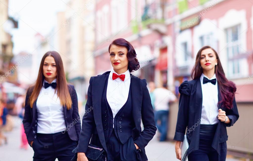 gorgeous women in black walking the city street