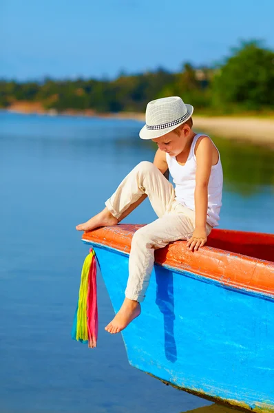 Cute kid, boy sitting on the bow of a boat — Stock Photo, Image