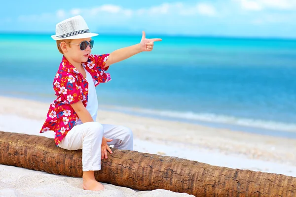 Cute boy playing a gangster on summer beach — Stock Photo, Image