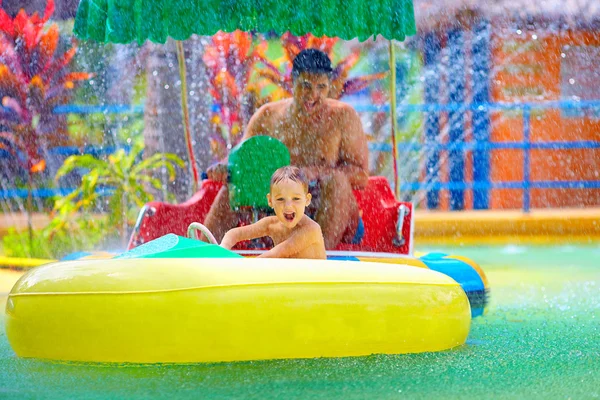 Family drive watercraft in aqua park, trying to hit each other — Stock Photo, Image