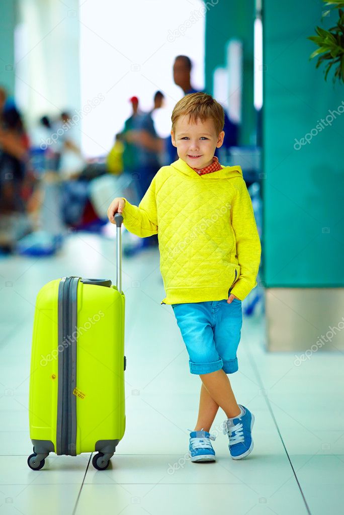 cute boy with luggage in airport, ready for summer holidays