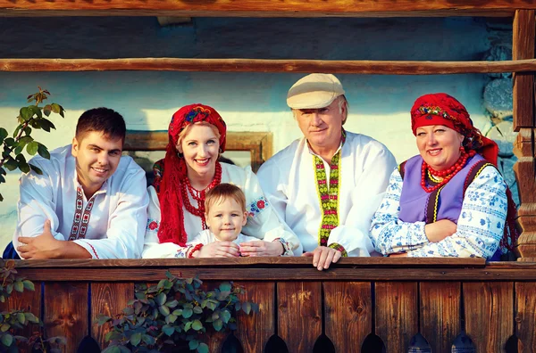 Feliz familia ucraniana en el porche de madera —  Fotos de Stock