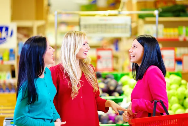 Amis heureux faisant du shopping ensemble dans un supermarché d'épicerie — Photo