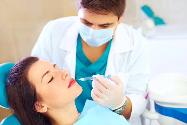 Young woman on rejuvenation procedure in beauty clinic, filler injection — Stock Photo, Image