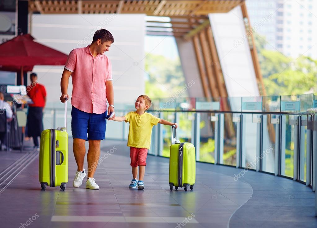 happy father and son are ready for boarding in international airport