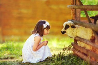 cute girl, kid feeding lamb with grass, countryside clipart